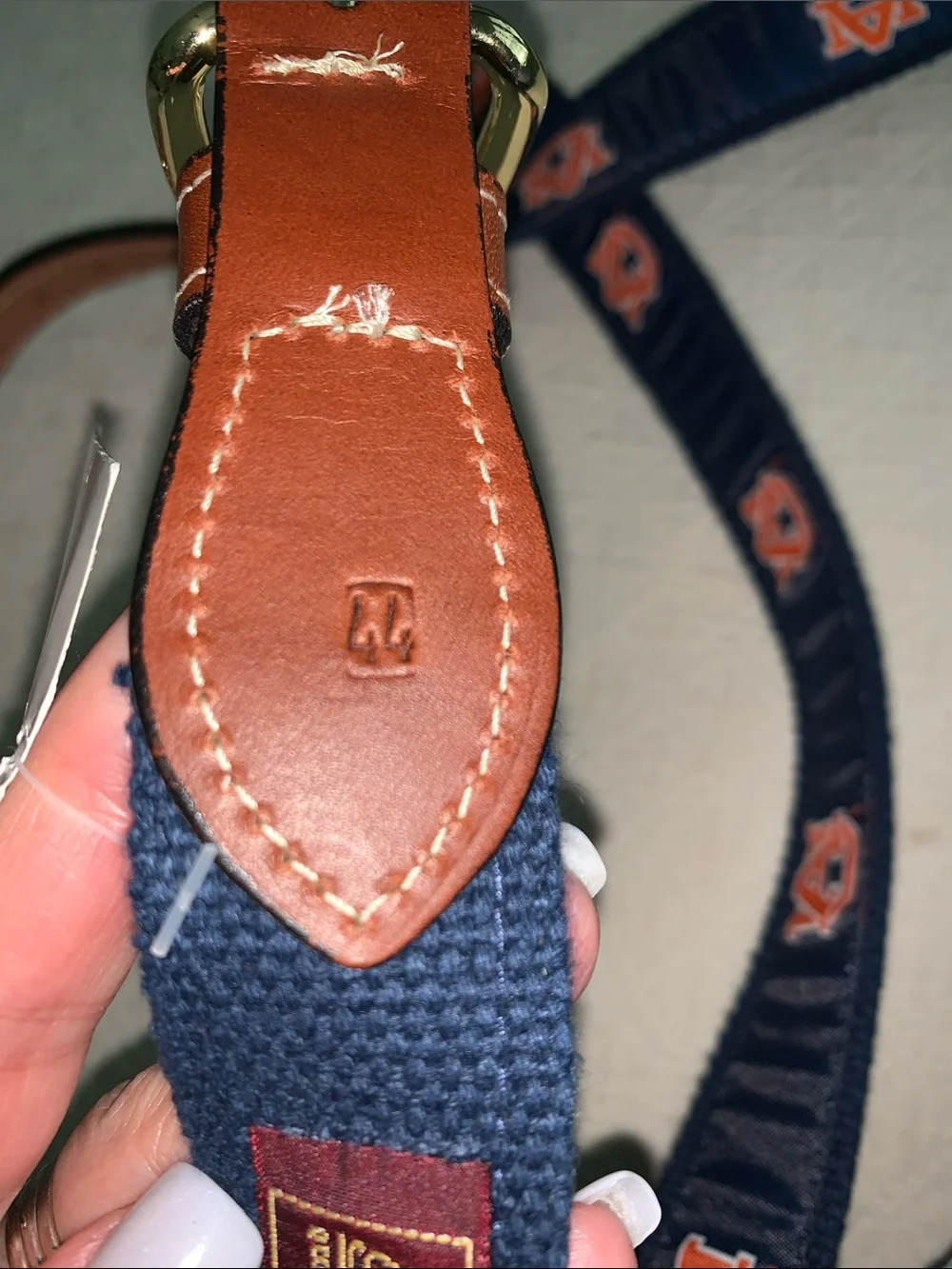 Navy Web Belt with Orange Logo Accents and Brown Leather Trim